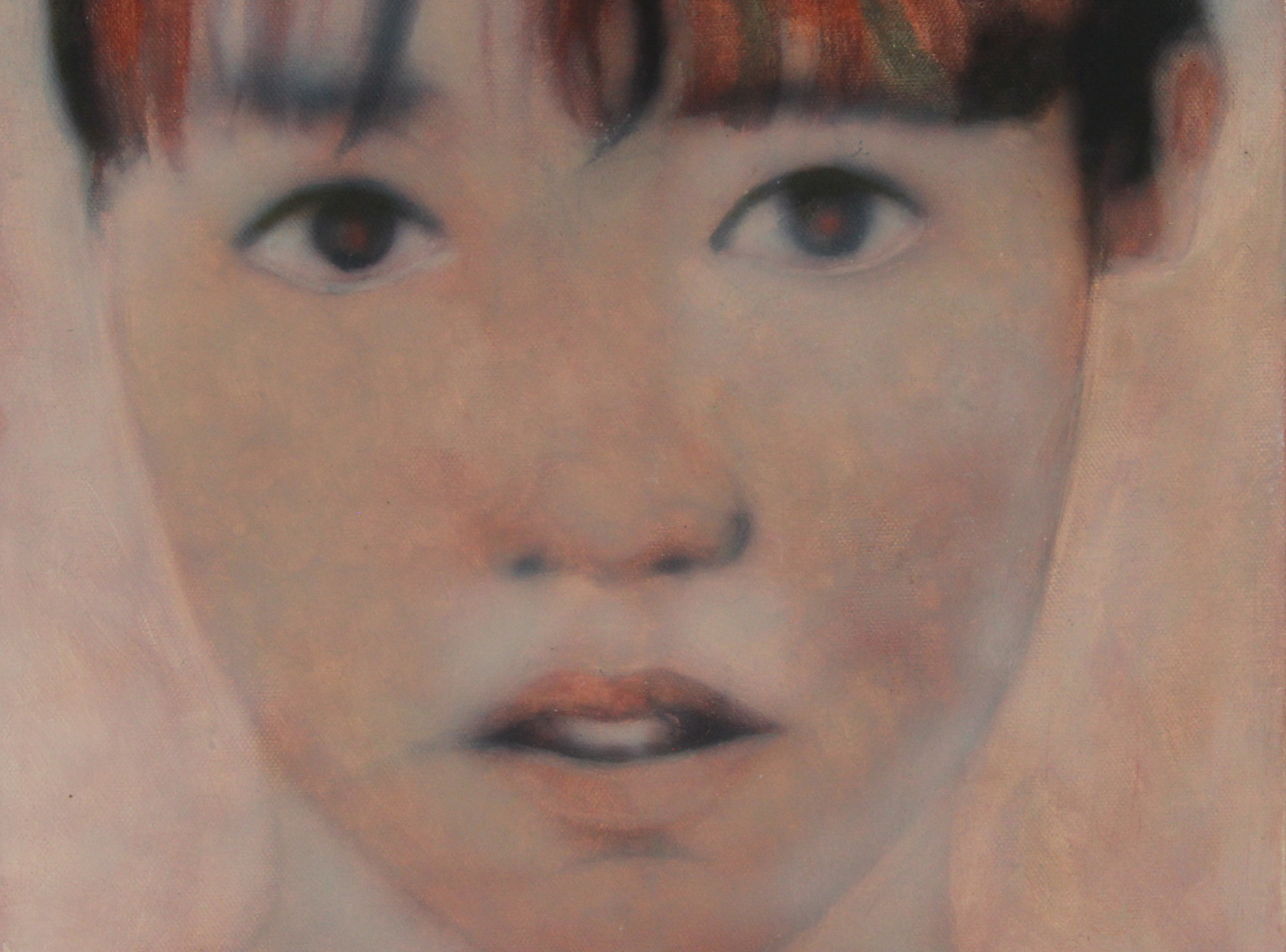 Close-up of a young face with eyes and lips visible through a soft, painterly texture.